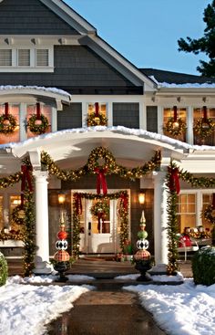 a house decorated for christmas with wreaths and lights