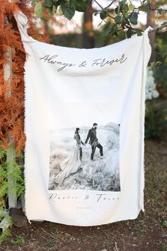 a wedding photo hanging from a tree