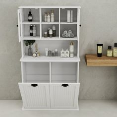 a white shelf filled with lots of different types of bottles and containers next to a wooden table