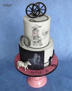 a three tiered cake with an image of a horse and carriage on it