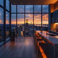 an empty bar in the middle of a room with large windows overlooking cityscape