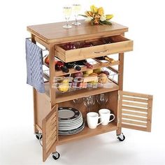 a kitchen cart with dishes and glasses on it