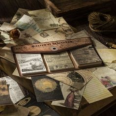 an assortment of old fashioned papers and other items on a table with twine rope