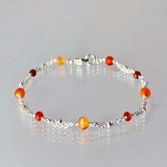 Genuine, premium-quality shaded carnelian bracelet, wire-wrapped in sterling silver This dainty but vibrant, orange crystal bracelet is designed with genuine, alternating 4 and 3 mm, micro-faceted, ombré carnelian balls, evenly spaced along sterling silver chain.  This bracelet is finished with a sterling silver lobster-claw clasp.  A bracelet suitable for one of any age ! Details: bracelet length: please choose at check-out genuine faceted carnelian balls:  4 and 3 mm sterling silver chain and clasp Thanks for visiting ! Back to my shop for more jewelry options: www.etsy.com/shop/krisatdesigns Green Gemstone Bracelet, Stacked Beaded Bracelets, Carnelian Bracelet, Pearl Drop Necklace, Blue Topaz Bracelet, Carnelian Jewelry, Emerald Bracelet, Vintage Style Earrings, Orange Crystals