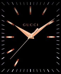 a clock with the word gucci on it's face in gold and black