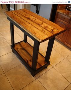 a wooden table sitting on top of a kitchen floor