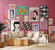 a living room with pink walls and lots of pictures on the wall, including a couch