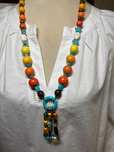 A single strand with pendant.  Another necklace that remind me of Aztec  culture.  A fun and multi colored necklace. Multicolor Adjustable Lariat Necklace, Multicolor Lariat Long Necklace For Gifts, Adjustable Multicolor Lariat Long Necklace, Bohemian Necklace With Colorful Beads And Round Pendant, Vibrant Adjustable Rainbow Necklace, Adjustable Multicolor Round Pendant Jewelry, Vibrant Rainbow Adjustable Necklace, Colorful Adjustable Vibrant Necklace, Unique Multicolor Beaded Necklaces For Beach