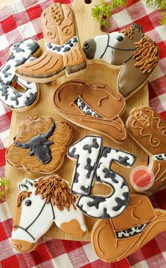 decorated cookies are arranged on a wooden tray