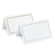 two white cards with gold trims on them