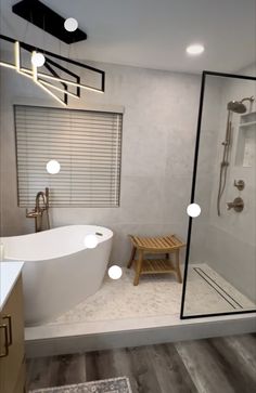 a white bath tub sitting next to a walk in shower