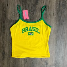 Yellow And Green Brazil Tank Top #Brazil #Tanktop #Newwithtags Trendy Yellow Sleeveless Top, Sporty Yellow Tops For Summer, Yellow Tank Top With Graphic Print For Spring, Casual Yellow Top With Tank Straps, Yellow Racerback Tank Top Casual Style, Yellow Graphic Print Tank Top For Spring, Brazil Top Outfit, Yellow Summer Tops With Letter Print, Brazil Outfits