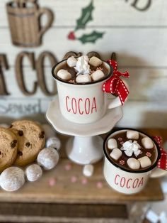 two mugs filled with hot chocolate and marshmallows