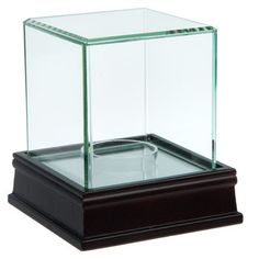 an empty glass box on top of a wooden base