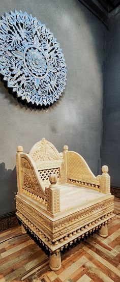 a wooden bed sitting on top of a hard wood floor next to a blue wall