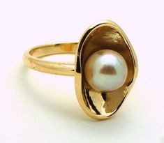 Golden Pearl Ring, Oval Yellow Gold Pearl Ring With High Luster, Oval Pearl Ring In Yellow Gold With High Luster, Modern Yellow Gold Pearl Ring For Anniversary, Yellow Gold Oval Pearl Ring With Polished Finish, 14k Gold Pearl Ring With High Luster, Modern Round Pearl Ring In Yellow Gold, 14k Yellow Gold High Luster Pearl Ring, Fine Jewelry Yellow Gold Pearl Ring With High Luster