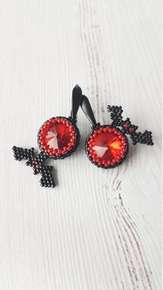 This earrings was made from black japanese MIYUKI and shimmer red glass crystals These earrings can be a great gift for your family and friends for the Halloween holiday. Also you can buy them for yourself on Halloween as an addition to your costume or separately as decorations for creating a festive mood. Available in a different color, just contact me All products are 100% hand made, made with love especially for you Please note that due to lighting effects, monitor's brightness, contrast and Handmade Black Vampire Earrings, Handmade Gothic Earrings For Party, Gothic Handmade Earrings For Party, Handmade Red Crystal Earrings For Gift, Red Earrings As Halloween Gift, Red Earrings For Halloween Gift, Red Drop Earrings For Halloween, Handmade Black Crystal Earrings For Party, Beaded Halloween