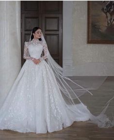 a woman in a white wedding dress and veil