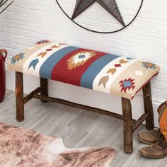 a wooden bench with a colorful blanket on it