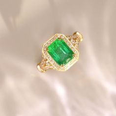 •Condition: Brand new•Center Stone: Natura emerald from Zambia, Emerald Cut approx 2.56ct•Side Stone: Natural white diamond, round cut, approx 0.48ct (VS1 clarity and F color) •Ring Weight: approx 3.79g•Metal Purity: Optional Each piece is made-to-order with care and special attention to detail. all items are made with conflict-free diamonds and gems.Size: made to orderThe item will be gift wrapped and shipped.---------------------------------------------------------Available in :14k Rose or Yel Luxury Emerald Ring For May Birthstone, Elegant Green Octagon Diamond Ring, Luxury Tsavorite Emerald Ring For Formal Occasions, Luxury Green Emerald Ring With Diamond Cut, Exquisite Green Emerald Ring With Pave Setting, Luxury Diamond Ring For May Birthstone, Elegant Gia Certified Emerald Ring, Luxury Gia Certified Emerald Ring For May Birthstone, Luxury Emerald Birthstone Ring