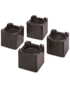 four black square shaped objects sitting on top of each other