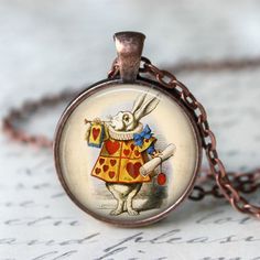 Handmade art pendant necklace featuring The White Rabbit from Alice in Wonderland. You can choose your finish between antique bronze, antique silver, antique copper or gunmetal. This beautiful pendant is handcrafted by me... using a high quality art print image and is protected by a beautiful crystal clear domed glass cabochon which enhances the image for a truly stunning effect! The glass cabochon measures approximately 1 inch in diameter. The pendant and chain are nickel-free plated alloy and Bronze Fantasy Necklace For Gift, Bronze Fantasy Necklace For A Gift, Bronze Fantasy Necklace For Gifts, Bronze Fantasy Necklace As A Gift, Whimsical Bronze Jewelry For Gifts, Alice In Wonderland Jewelry, Wonderland Jewelry, Rabbit Alice In Wonderland, White Rabbit Alice In Wonderland