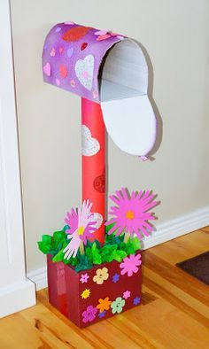 a paper bag with flowers in it and a mailbox shaped like a flower pot