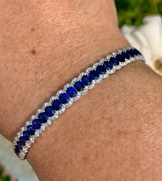 "Gorgeous Sapphire and Diamond Bracelet. The blue sapphires are a deep blue color with lots of life to them; all well matched. All REAL stones. You can tell it's blue right away, unlike some sapphires that are so dark they look black. Excellent craftsmanship, the row of blue sapphires are framed on each side by a scalloped row of sparkling diamonds. All stones are set smooth. The lock is easy to work and very secure with safety latch. The width measures 7mm. Will fit 7\" wrist comfortably. One O Ombre Rings, Morganite Engagement Ring Oval, Sapphire Bangle, Bracelet White Gold, Blue Sapphire Bracelet, Flower Diamond Ring, Sapphire Bracelet, Diamond Bangle, Tennis Bracelet Diamond