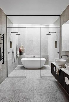 a bathroom with a tub, sink, and shower stall in it's center