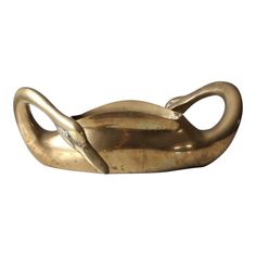 a gold colored object that is shaped like a cat's tail and has its eyes closed