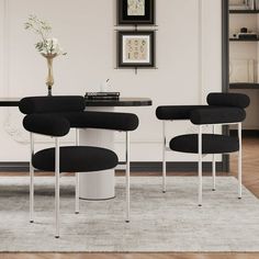 a dining room with black chairs and a white table