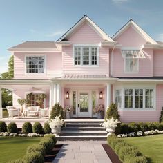 a pink house with white trim on the front door and steps leading up to it