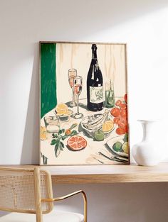 a painting on the wall next to a chair and table with wine glasses, oranges and fruit