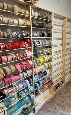 a room filled with lots of different types of ribbons on shelves next to each other