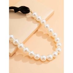 This unique faux pearl necklace is an eye catching beauty that will staple your elegant style. Perfect to complete a glamorous look. Features: Faux Pearl with Velvet self tie. Size: Line of pearls - 21.5", Velvet tie 7.75" Color: Ivory/Black Black Velvet Ribbon, Velvet Tie, Ribbon Choker, Lip Palette, Perfume Making, Faux Pearl Necklace, Velvet Ribbon, Women Perfume, Mens Fragrance