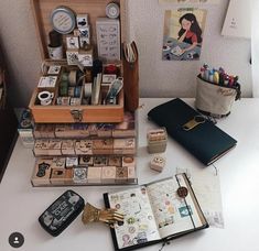 an open book sitting on top of a table next to some other items and papers