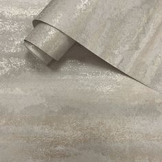 a roll of metallic foil on top of a wallpaper covered in white and silver glitter