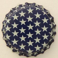 a blue and white plate with stars on the bottom is hanging from a wall in a room