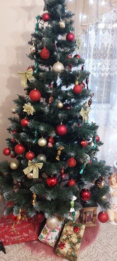 a decorated christmas tree with presents under it