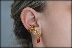 Gold and Red Ear Cuff/No piercing Ear Cuff/Crystal Ear Cuff/Wire Wrapped Ear Cuff/Raw Brass Ear Cuff/Cosplay Jewelry/Christmas Cuff/Gift For Her ❤️ Gold and Red wire wrapped ear cuff. No piercing required! The cuff is made with raw brass wires and is decorated with glass red and gold beads, a crystal faceted bead in the center and a red drop crystal bead hanging. The wires are covered with special lacquer for metals, to avoid quick tarnishing which is a natural procedure of brass. 🌷 Check my ot Ear Cuff Wire, Crystal Ear Cuff, Cosplay Jewelry, Wrap Earrings, Gold And Red, Greek Jewelry, Geometric Ring, Jewelry Christmas, Brass Jewelry