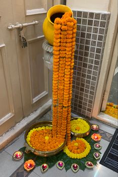 an arrangement of flowers and candles on the ground