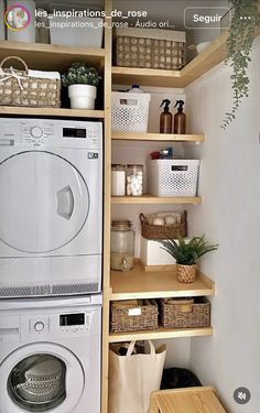 a washer and dryer in a small room with shelving on the wall