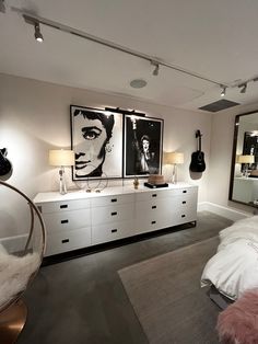 a bedroom with white furniture and pictures on the wall above it's dressers