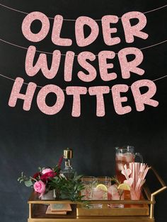 an old - fashioned bar cart with drinks on it and the words older wiser hotel above it