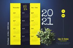 a yellow and black calendar is next to a potted plant on a blue background