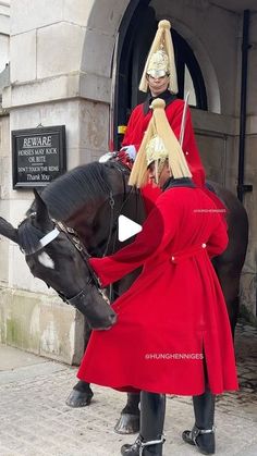 two men in red coats are riding on horses and one man is dressed as a roman soldier