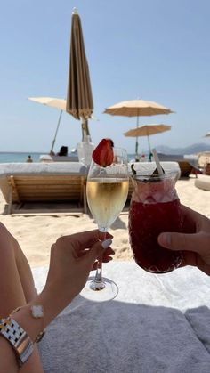 two people toasting with wine at the beach