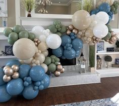 balloons are arranged in the shape of flowers on a fireplace mantel above a mantle