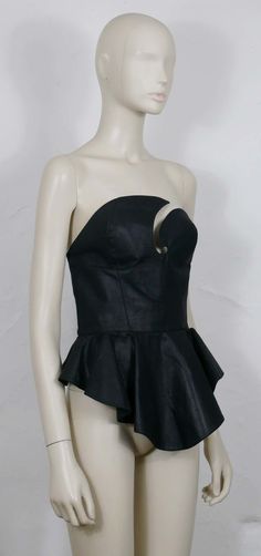 For Sale on 1stDibs - THIERRY MUGLER vintage iconic black bustier corset. This bustier features : - Black fabric (probably coated cotton). - Asymetric bust. - Basques. - Back Black Bustier, Thierry Mugler, Black Fabric, For Sale, Fabric, Clothes, Black