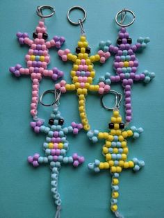 four beaded keychains are arranged on a blue surface